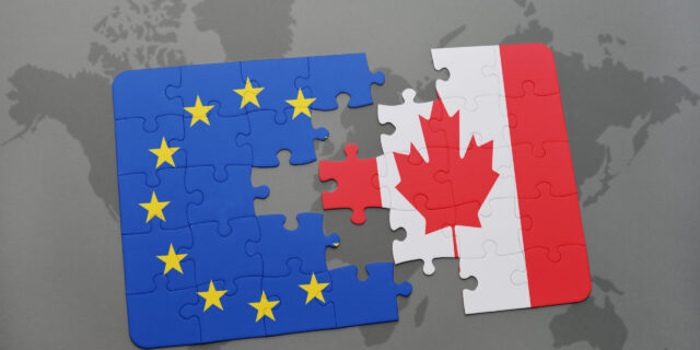 A puzzle with the national flag of Canada and the European Union on a world map.